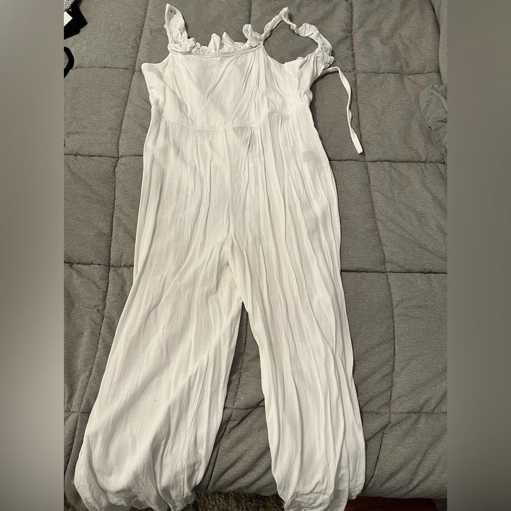 White jumpsuit with open back.